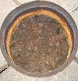 Picture of a restaurant floor grease trap before using NT-MAX grease trap treatment.